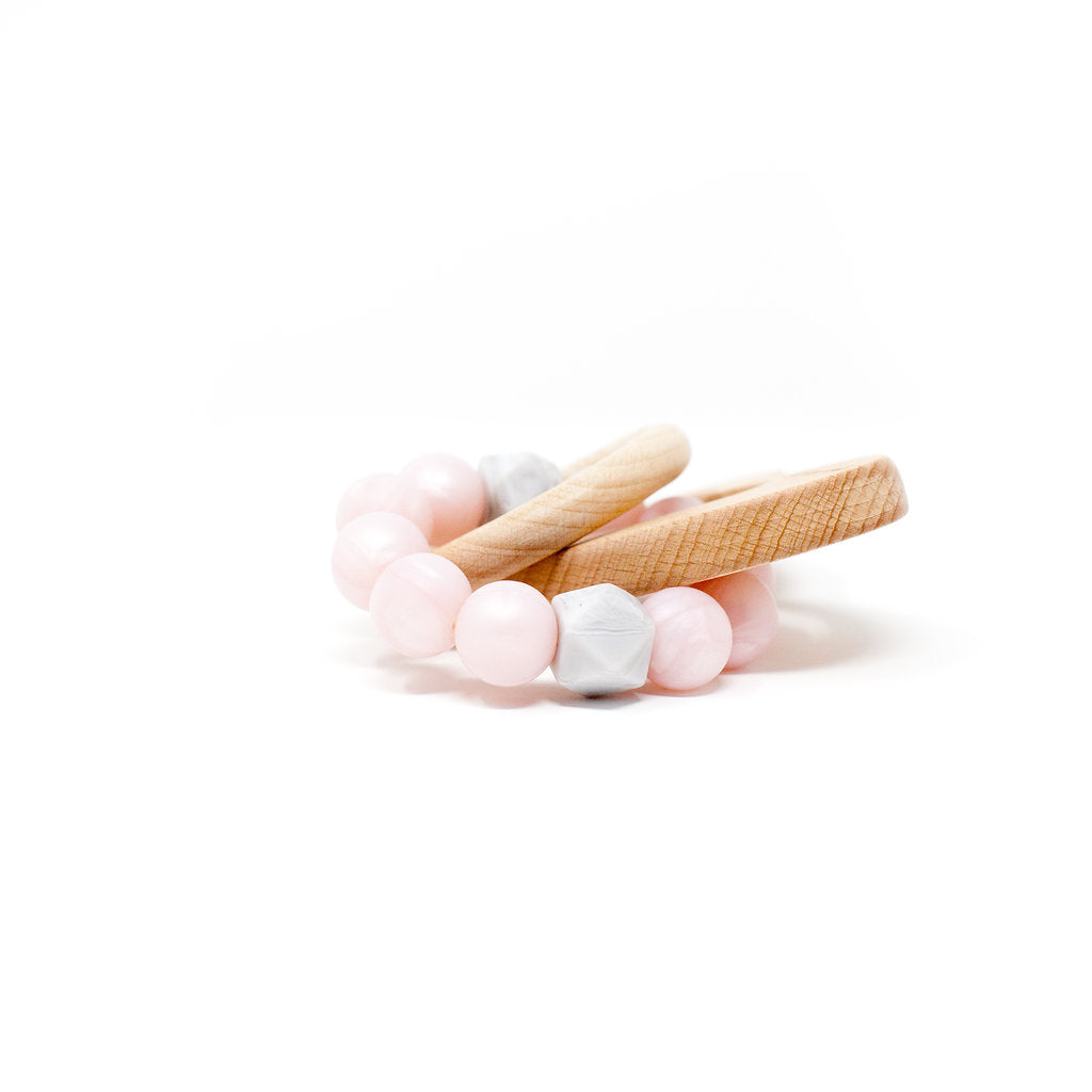 Set of pink and white beaded bracelets on a white background