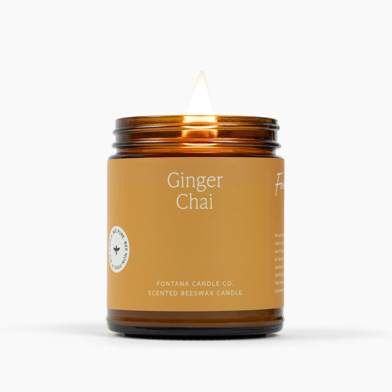 Ginger Chai candle in a glass jar with a label on a white background