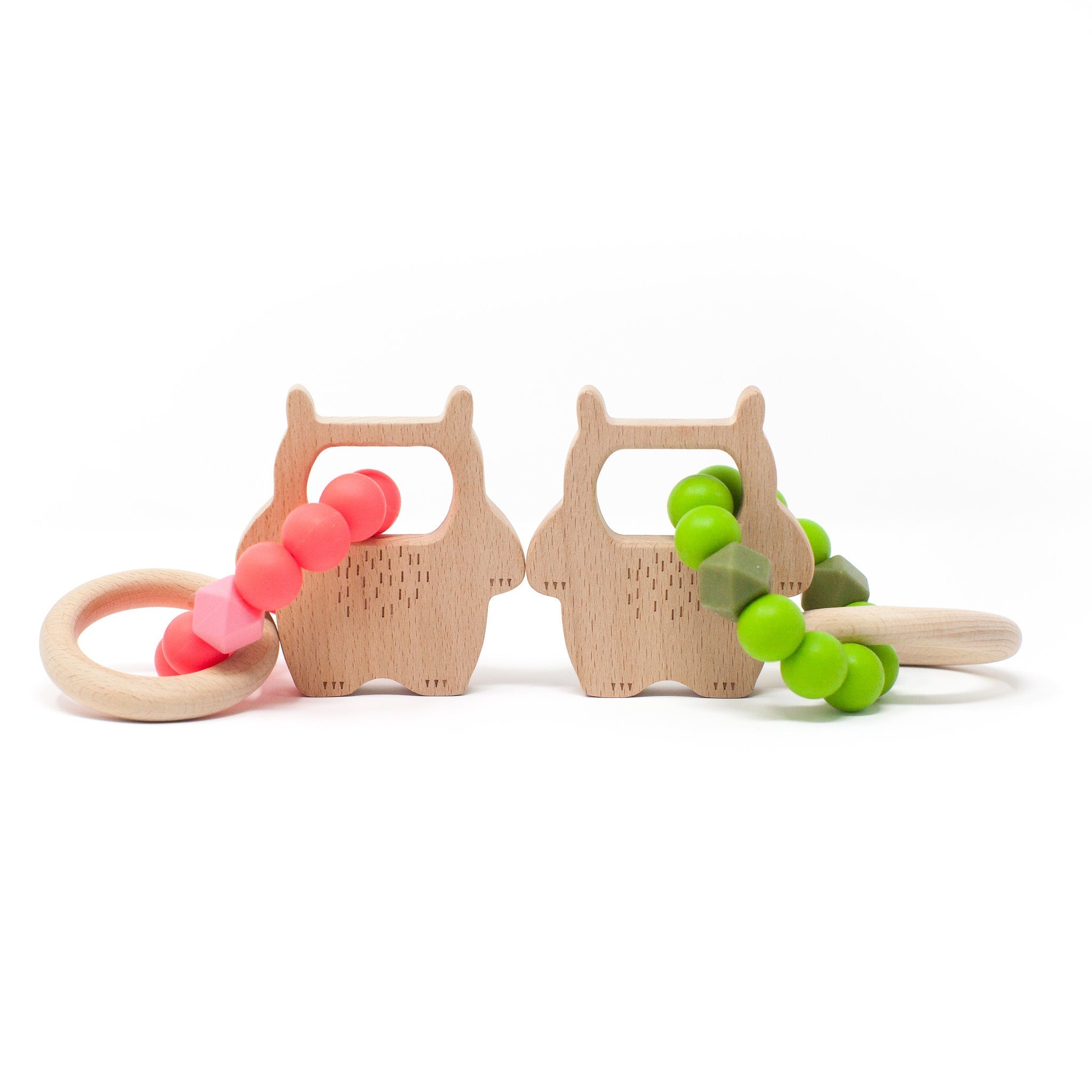 Two wooden teething rings with colorful beads on a white background