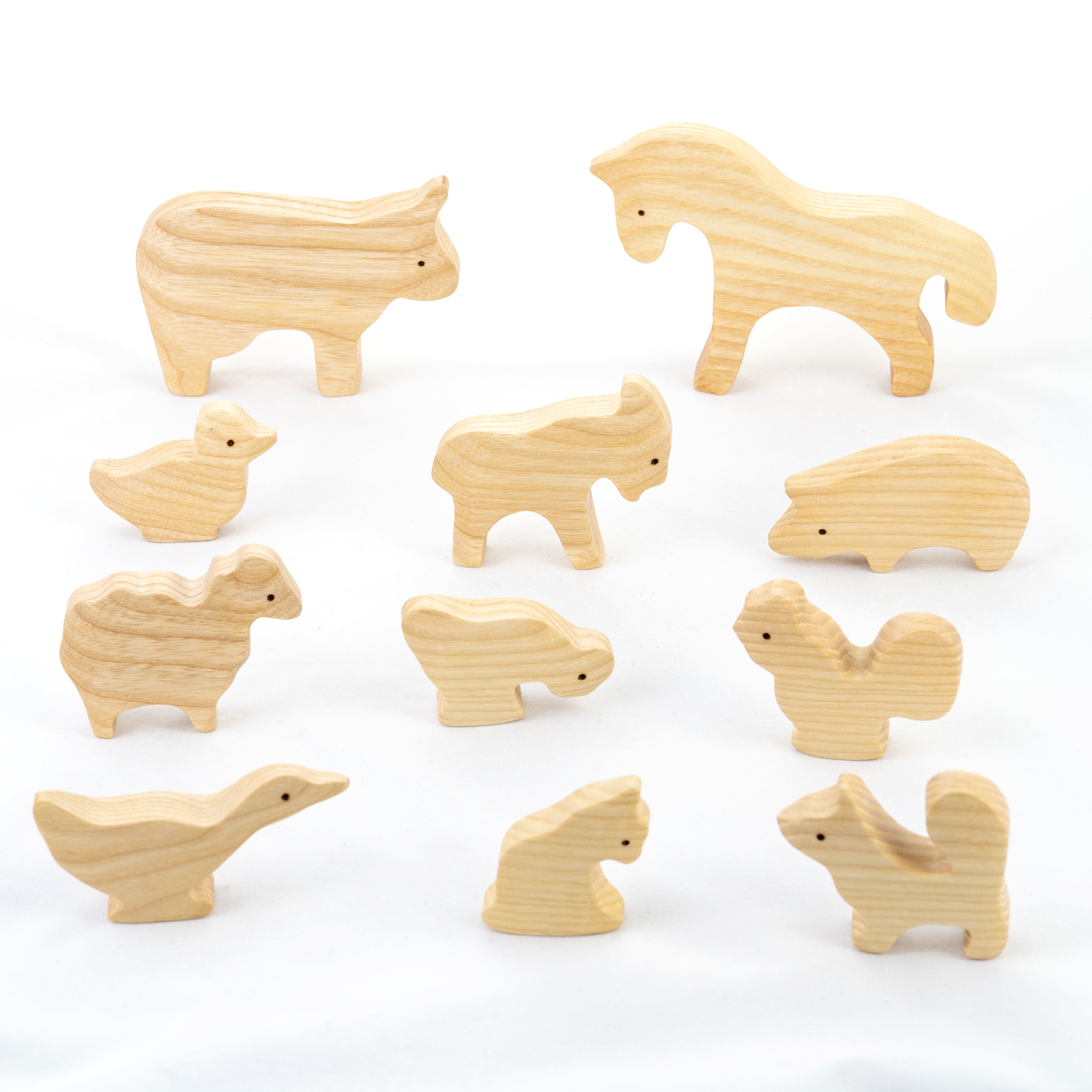 Set of wooden animal toys on a white background