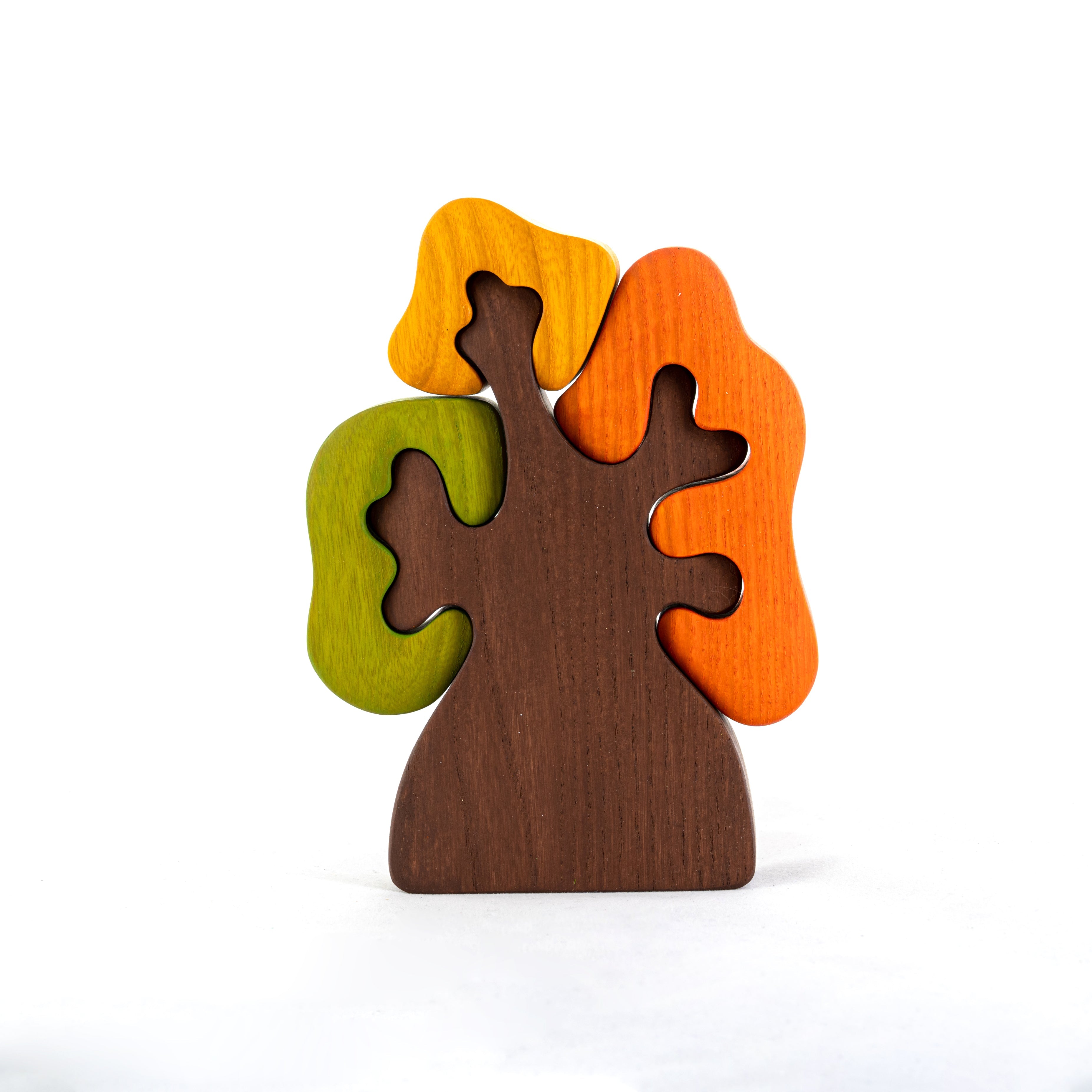 Wooden tree-shaped puzzle with colorful leaves on a white background