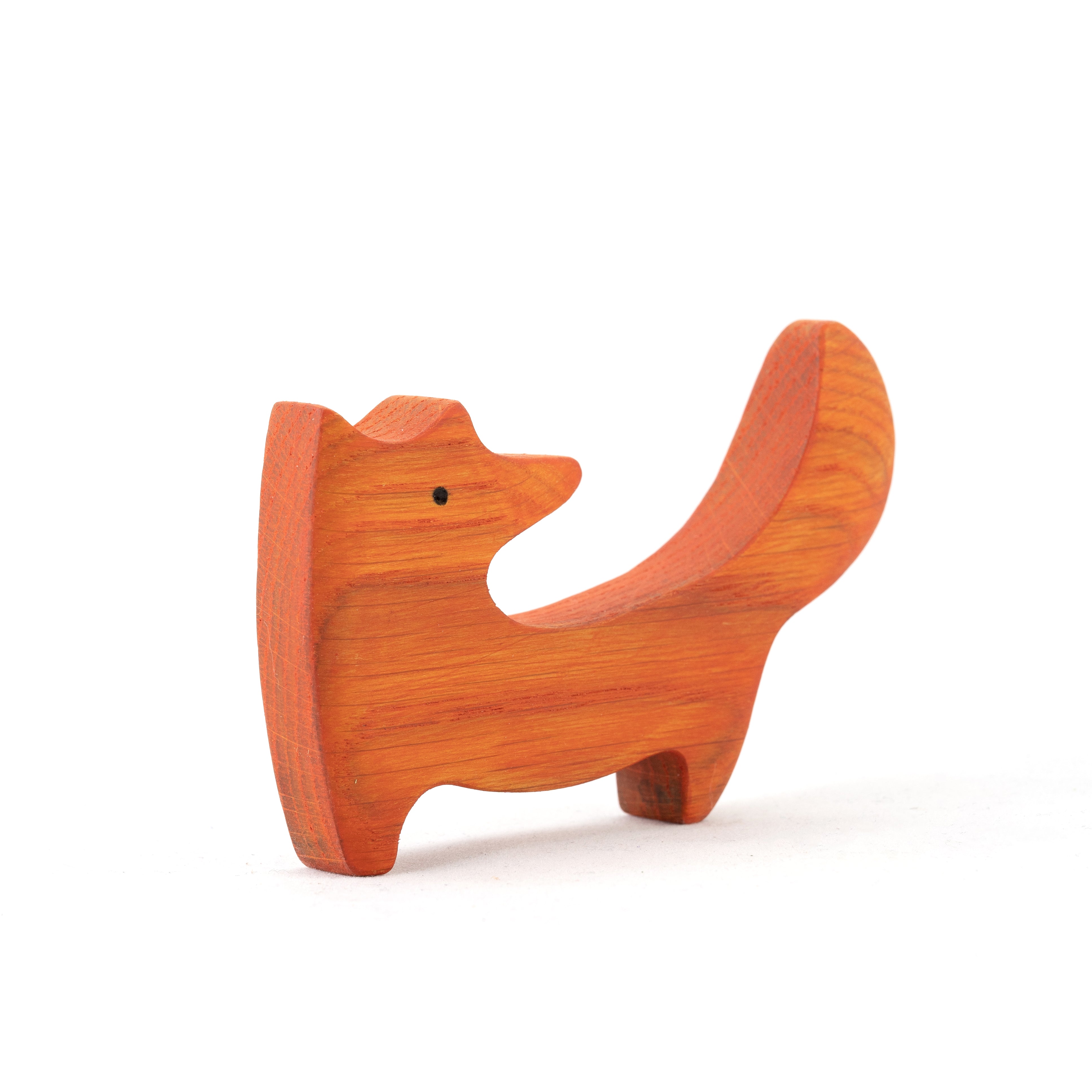 Wooden dog-shaped object on a white background
