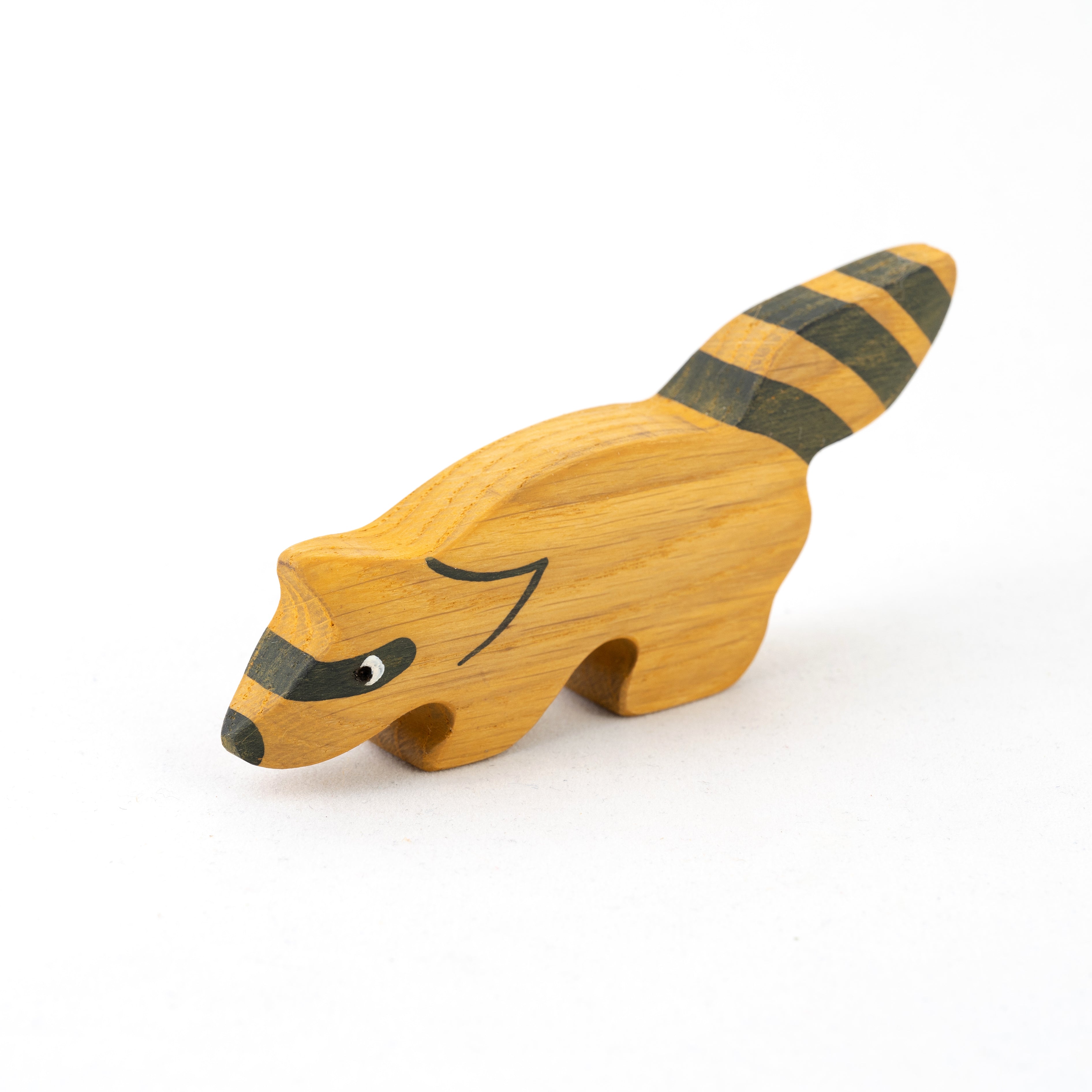 Wooden raccoon toy on a white background