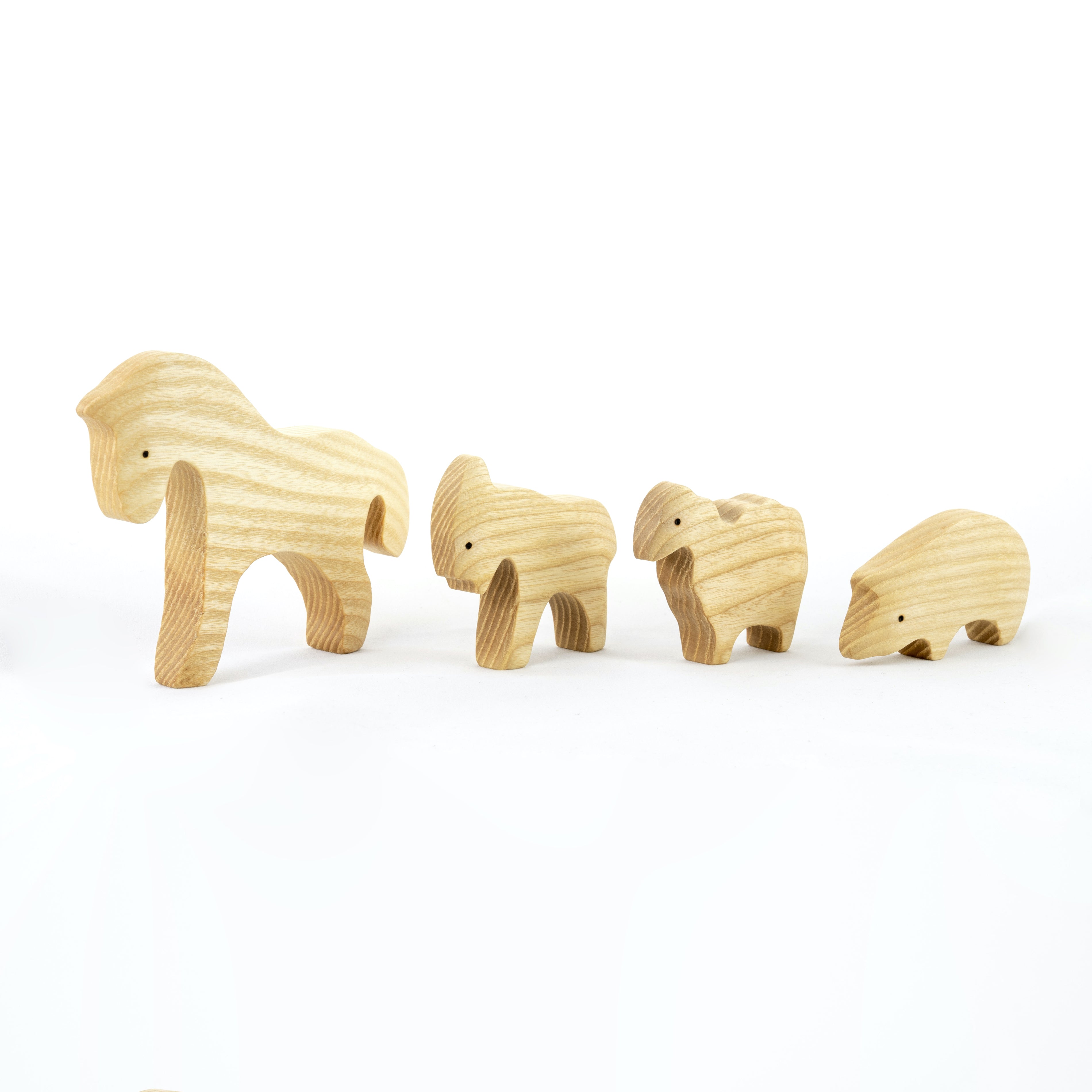 Set of four wooden animal figures on a white background
