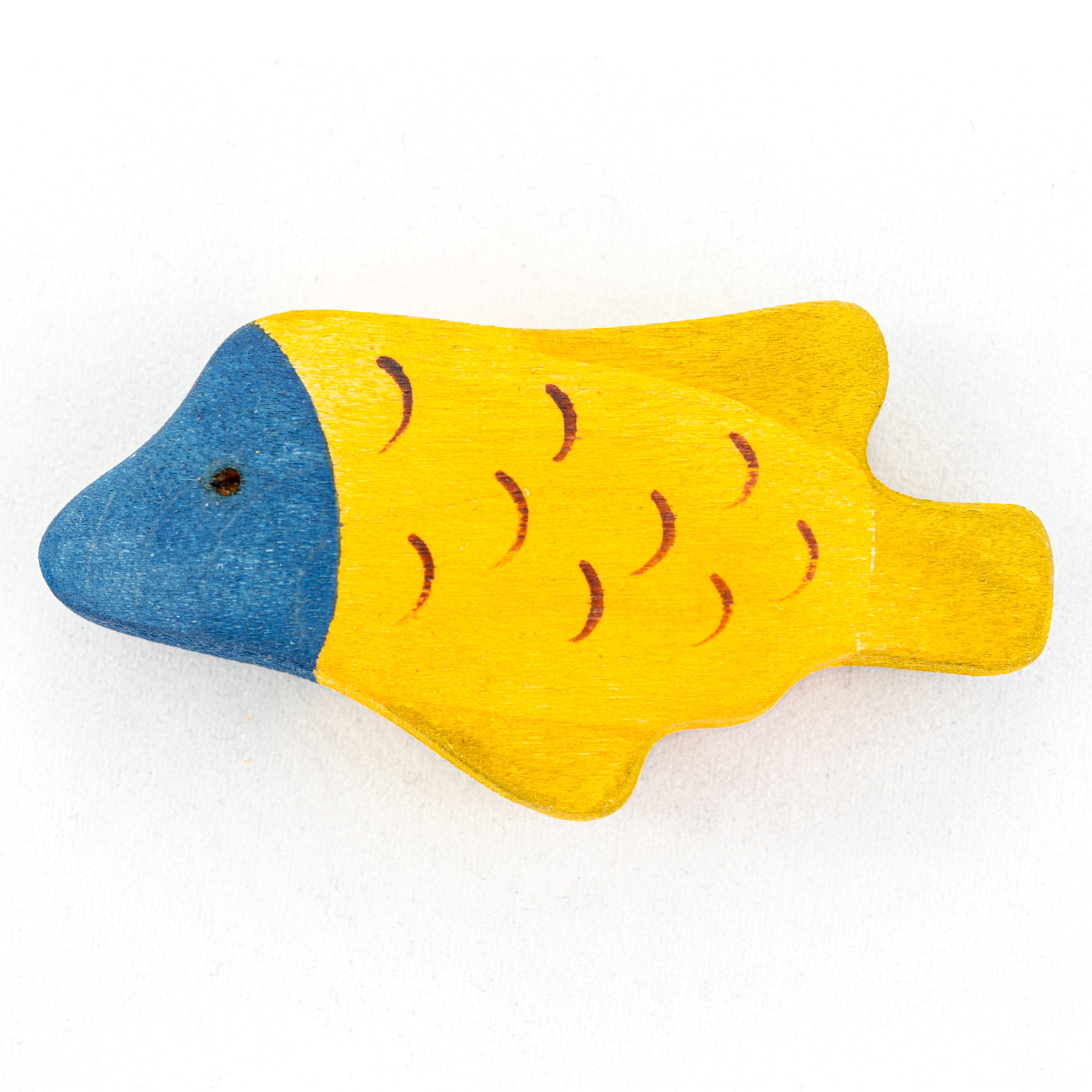 Wooden fish toy with blue head and yellow body on a white background