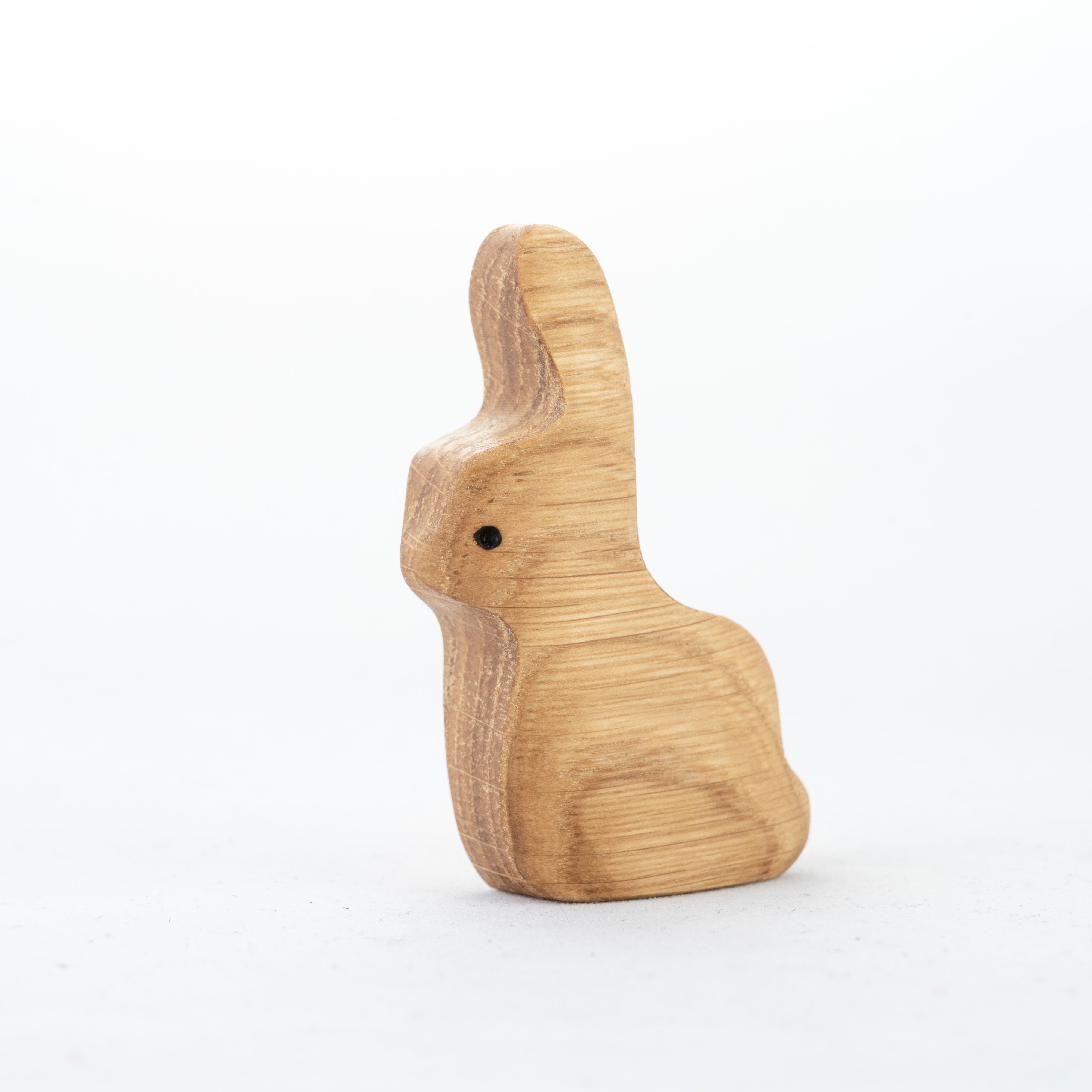 Wooden rabbit figurine on a white background