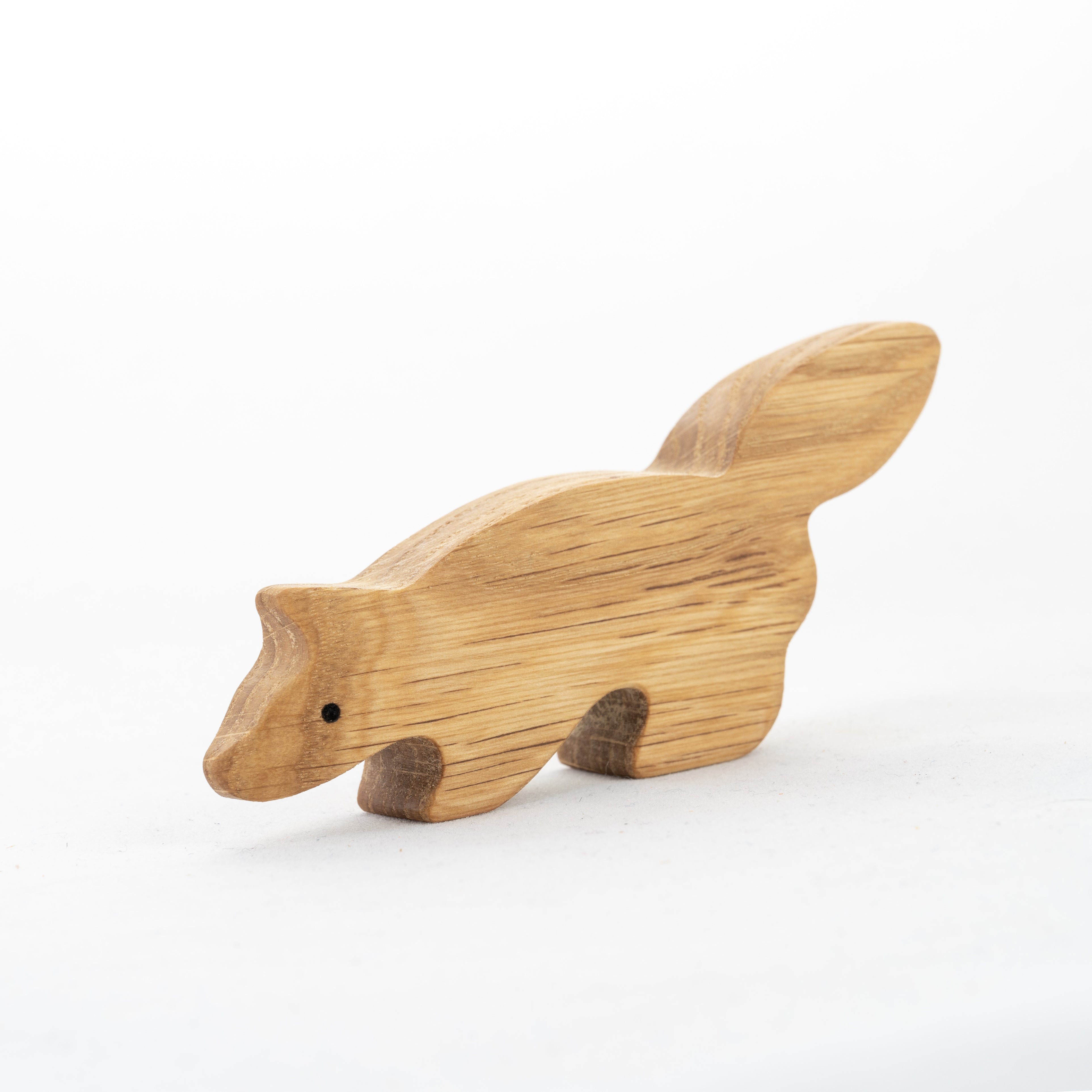 Wooden raccoon figurine on a white background