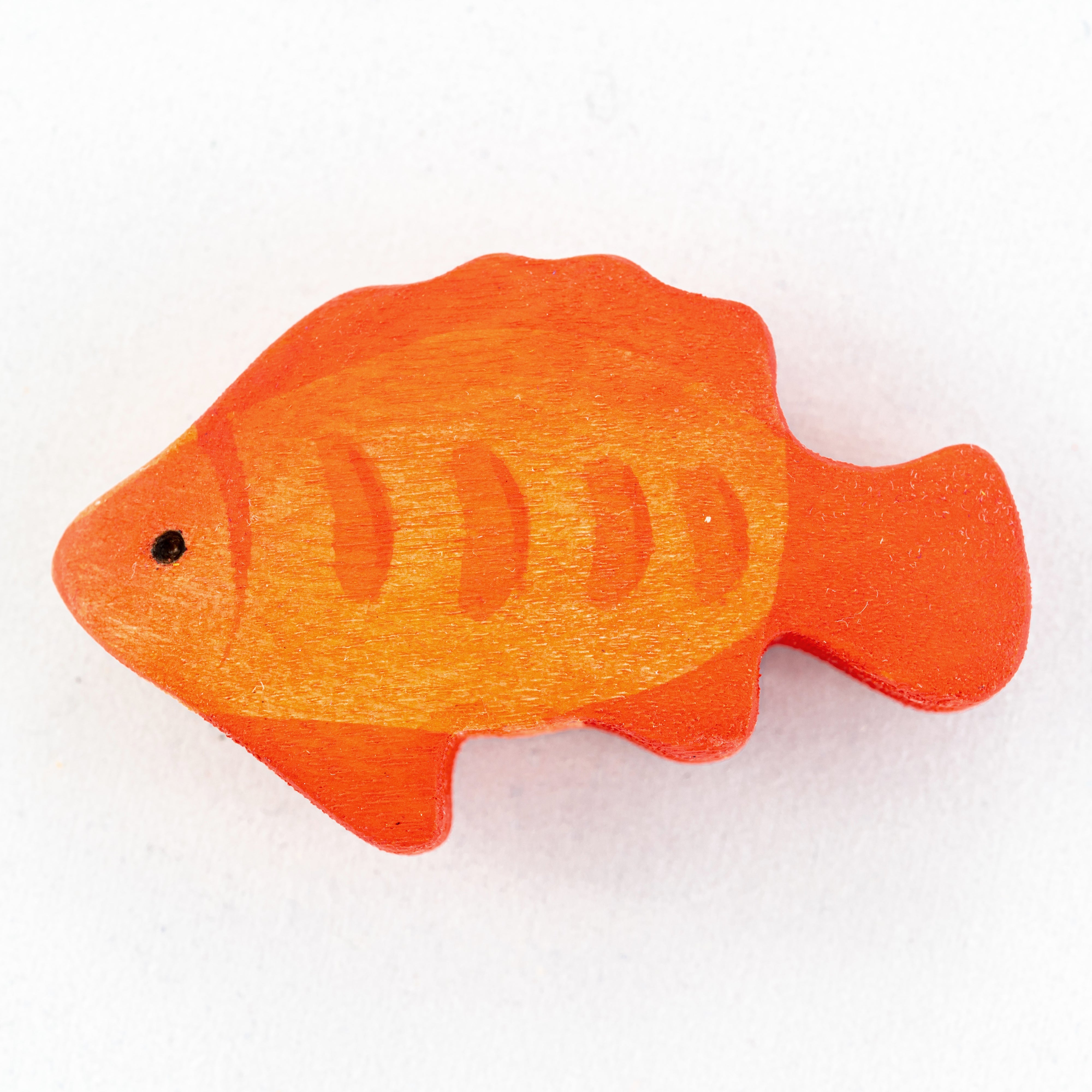 Orange fish-shaped object on a white background