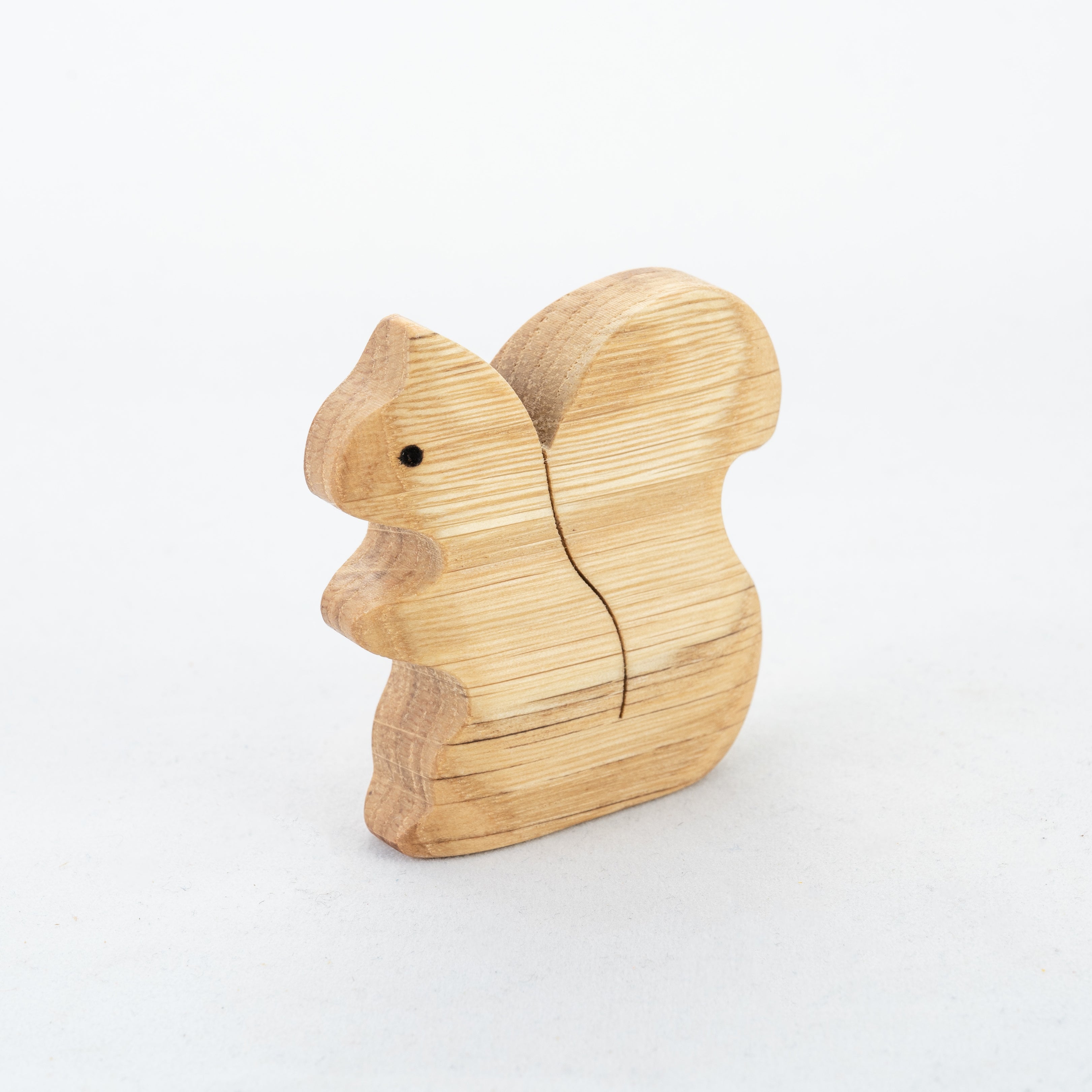 Wooden squirrel figurine on a white background