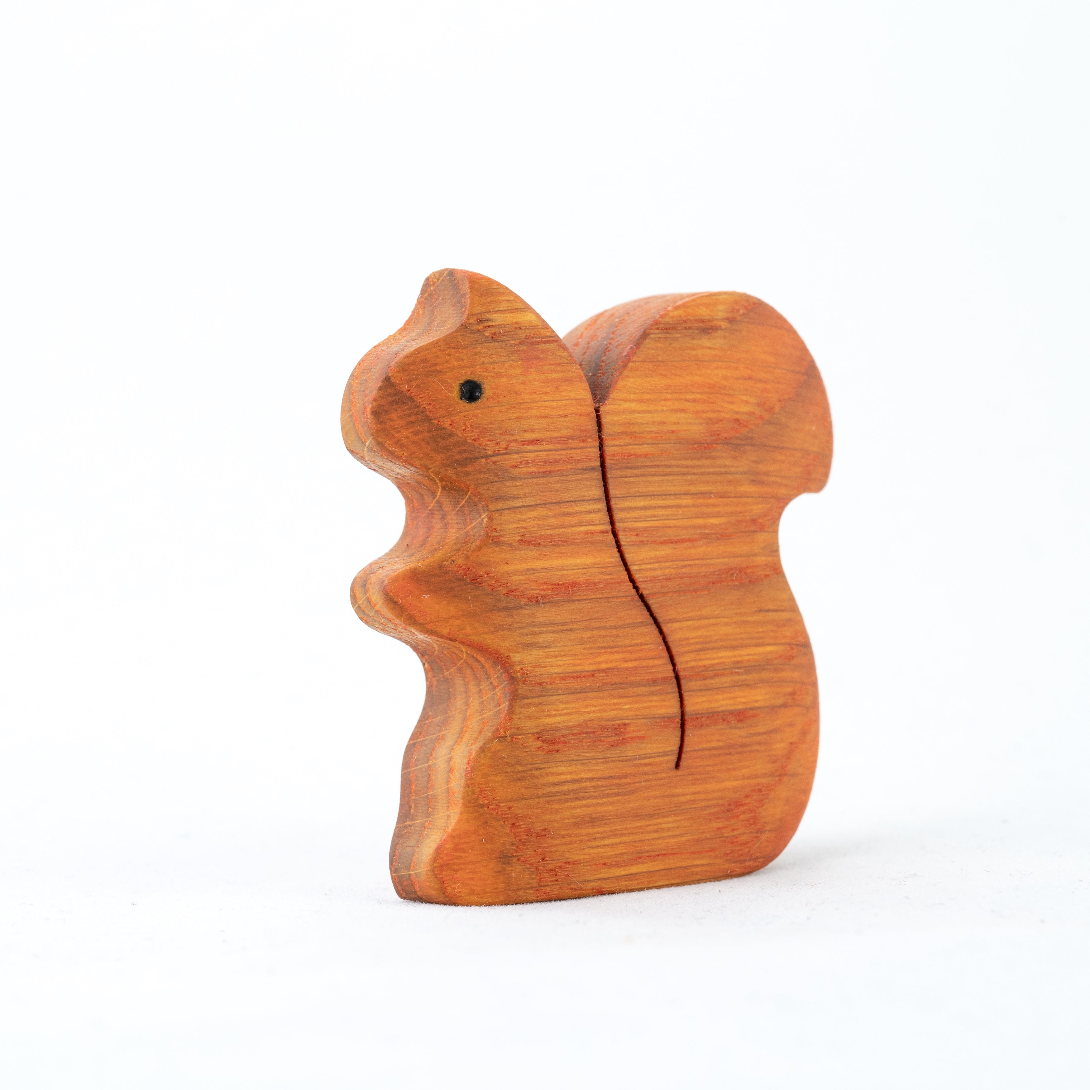 Wooden squirrel figurine on a white background