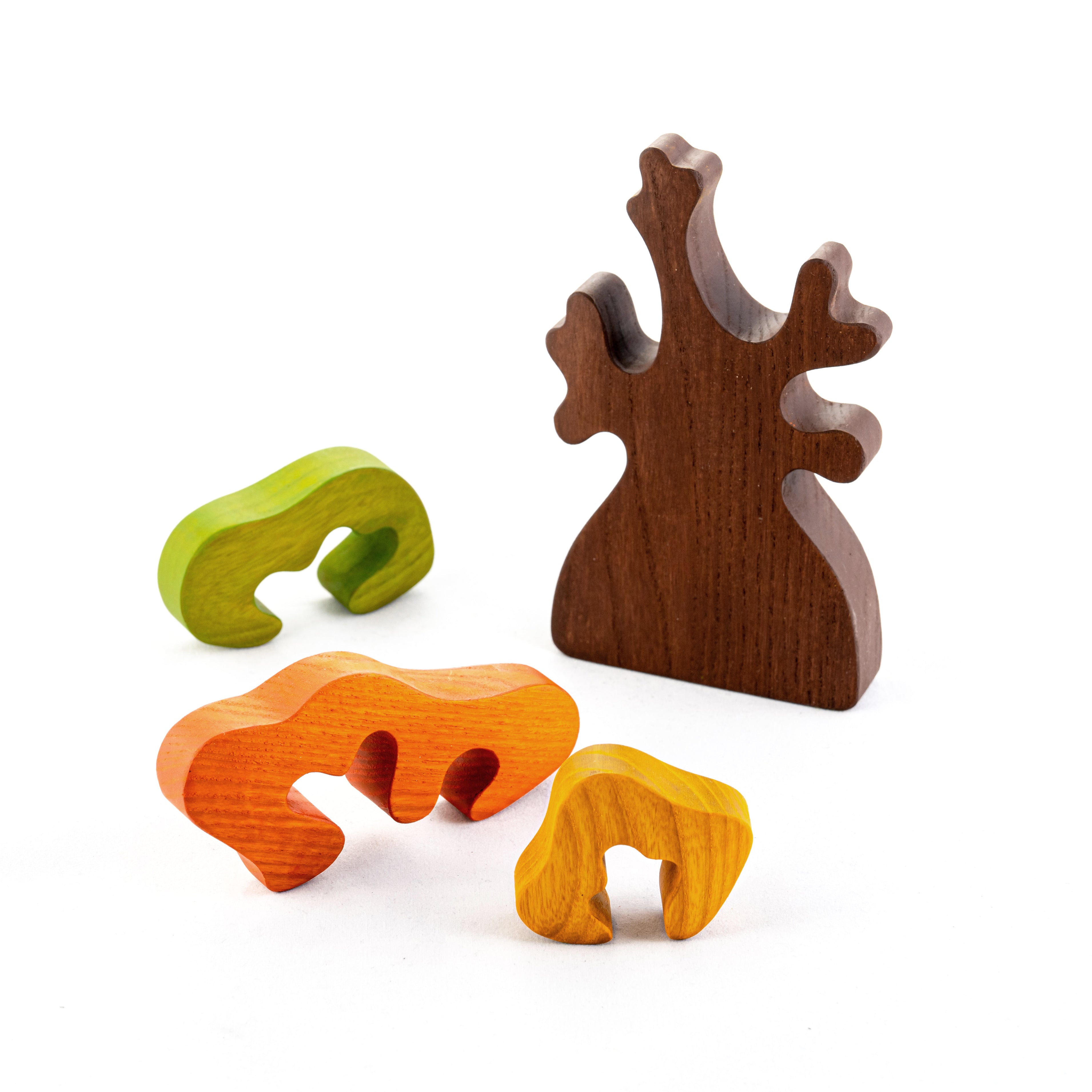 Set of four wooden animal figurines on a white background