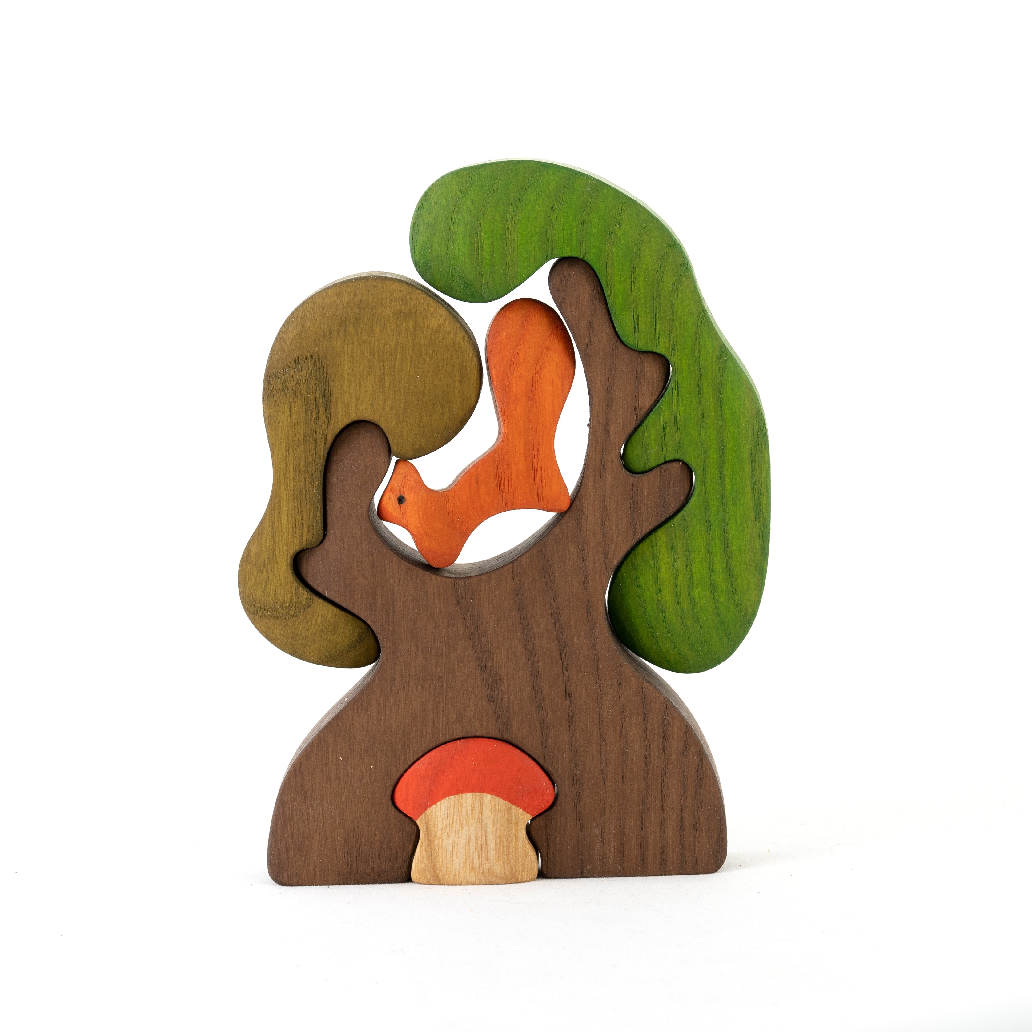 Wooden toy puzzle of a squirrel in a tree with a mushroom on a white background