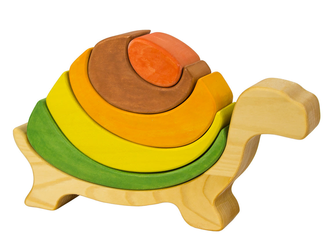 Wooden turtle puzzle toy with colorful rings on a white background