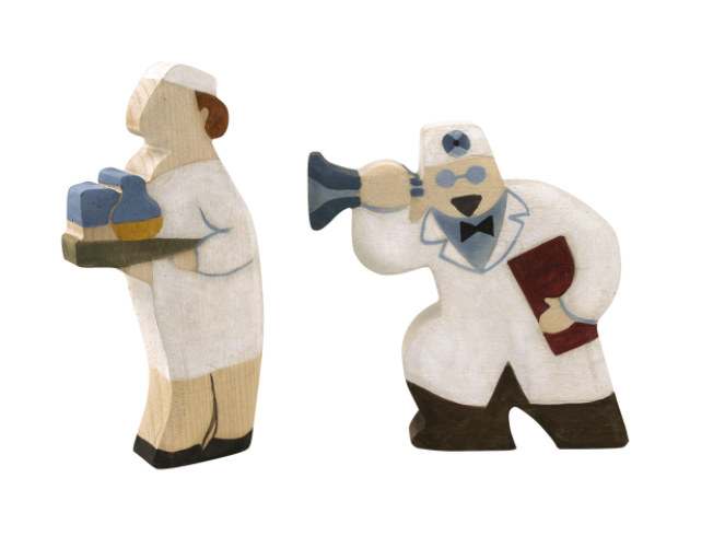 Two polar bear figurines dressed in human-like outfits on a white background