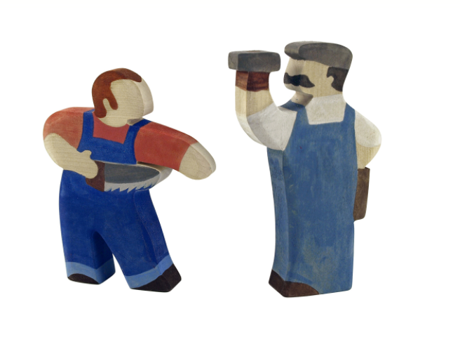 Two wooden figurines of workers in blue overalls on a white background