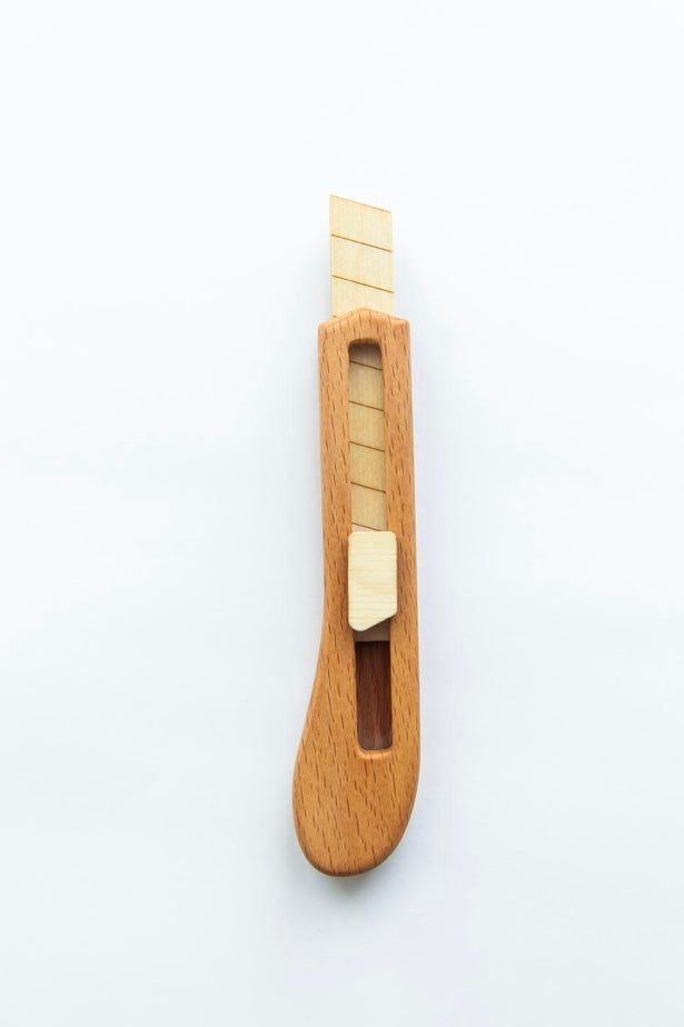 Wooden cutter with a blade on a white background