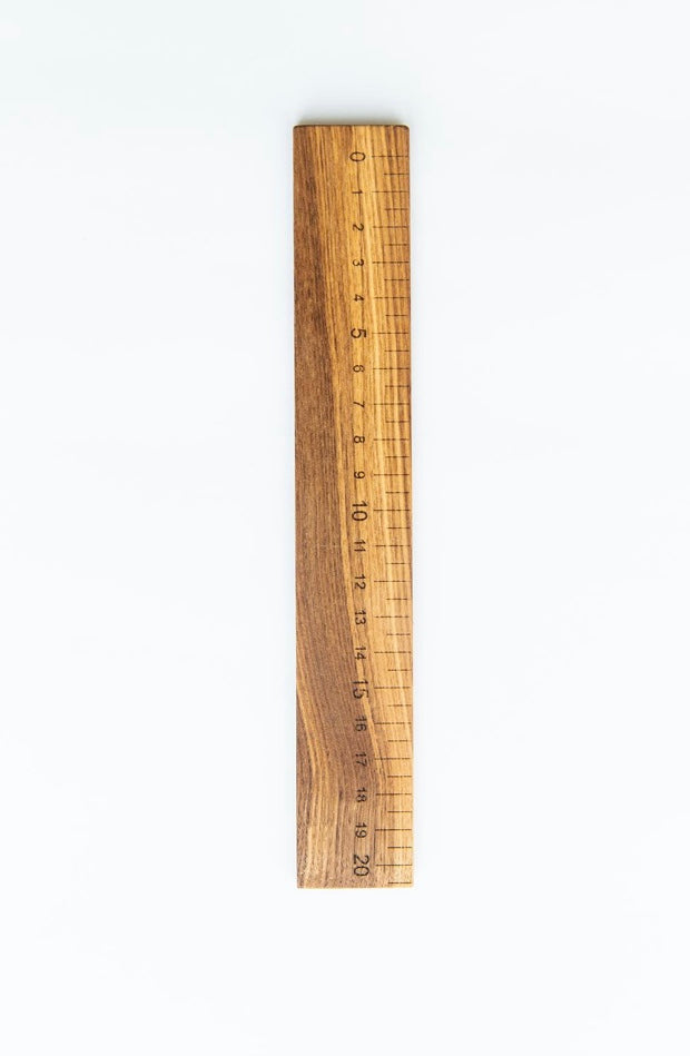 Wooden ruler with measurement markings on a white background