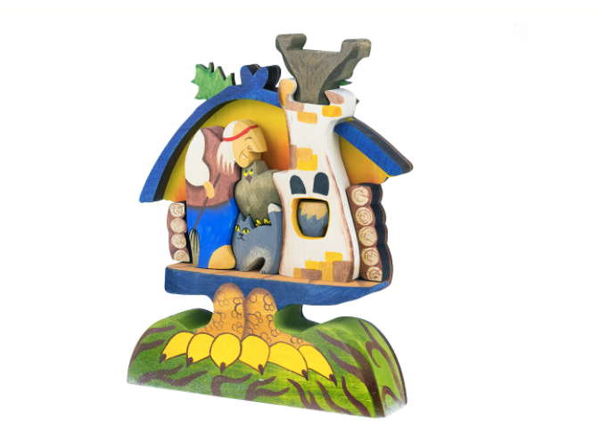 Wooden figurine with a house and animals on a white background