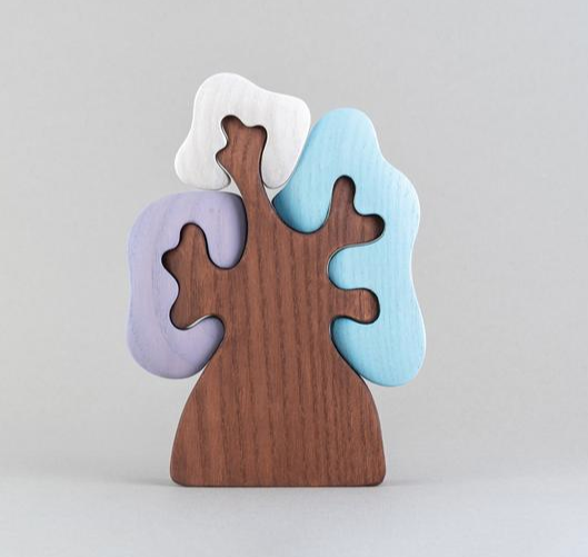 Wooden puzzle toy with colorful pieces on a light gray background