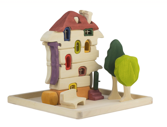 Colorful toy house with a tree on a white background