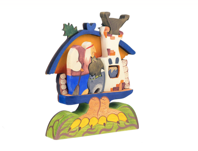 Wooden nativity scene figurine with stable and figures on a white background
