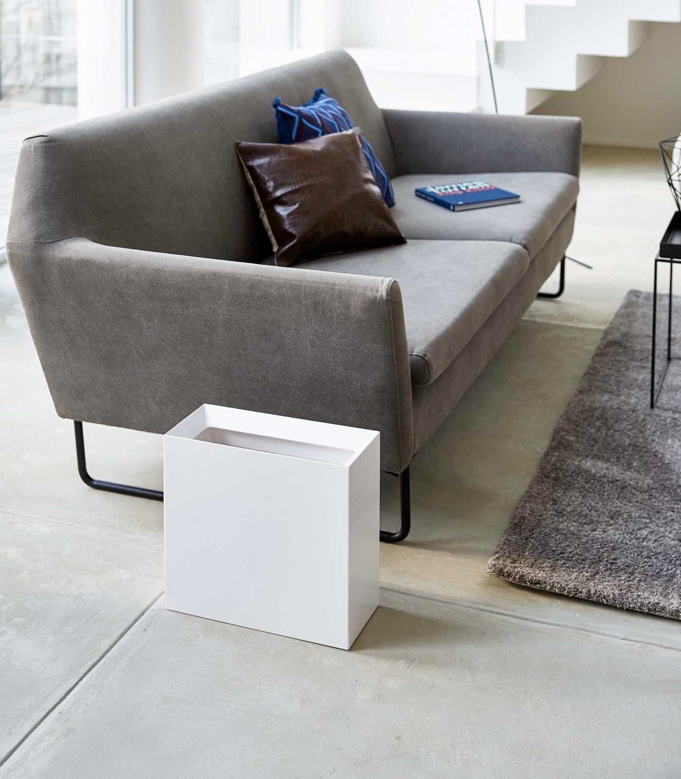 Gray sofa with cushions in a modern living room setting