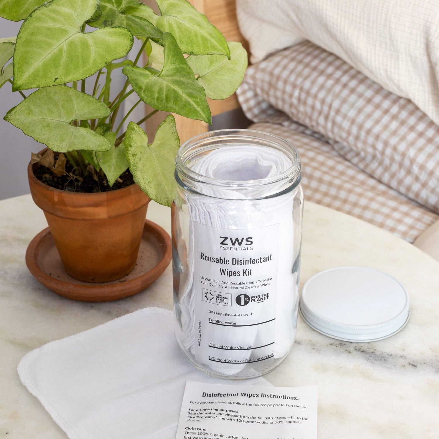 ZWS Reusable Disinfectant Wipes Kit on a marble surface with a plant in the background