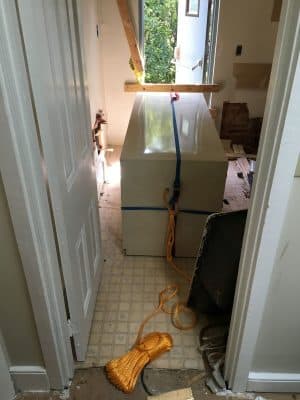 The 3rd floor bathroom also had this refrigerator to contend with; we opted to lower it out the window!