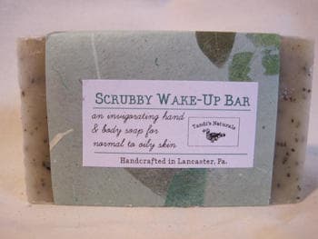 A bar of soap with a green label that reads Scrubby Wake Up Bar from Tandi's Naturals.