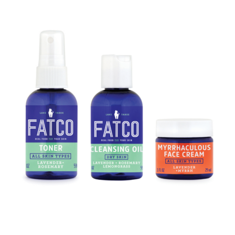An image showing two blue bottles of FATCO skin care serums and one orange tub of moisturizer.