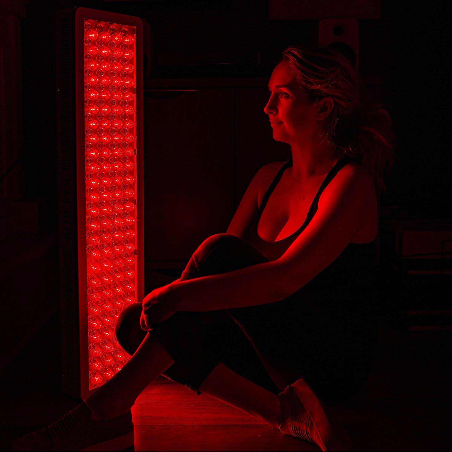 Image of woman using red light therapy. | Gimme The Good Stuff