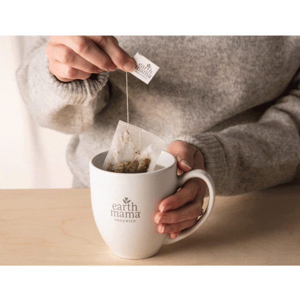 An animated image (gif) of a woman dipping a teabag into a mug that reads Earth Mama.