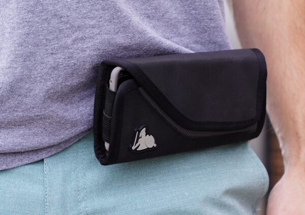 A close up of a man wearing a Cell Phone EMF Radiation Protection holster on his belt