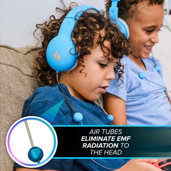 A young boy with curly hair sitting on the couch and listening to blue over-ear headphones.