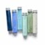 A collection of glass vials holding non toxic blue and green paints.