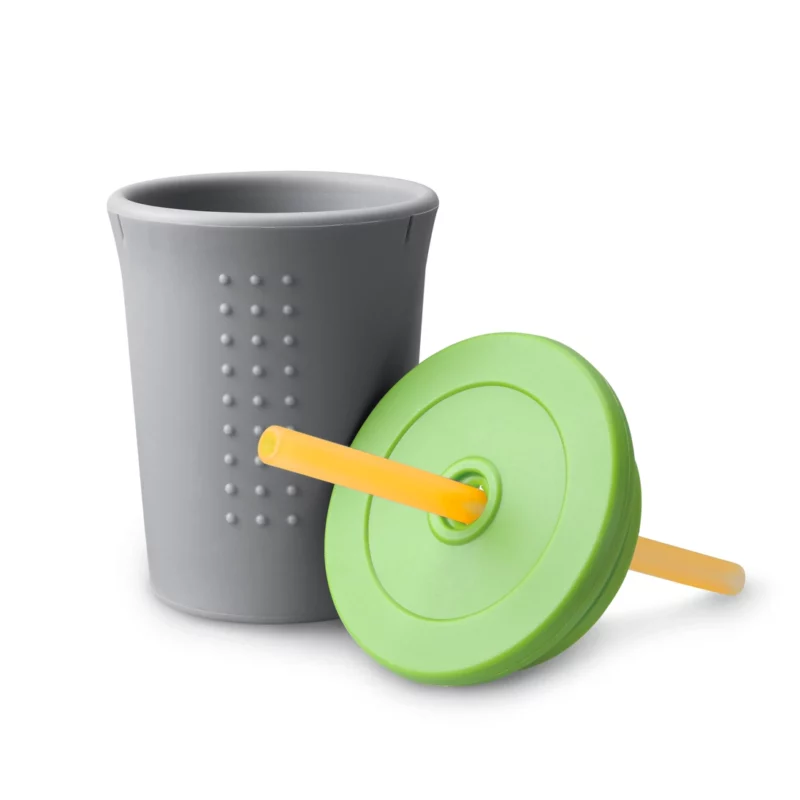 A grey and green silicone cup with a removable lid and a yellow straw.