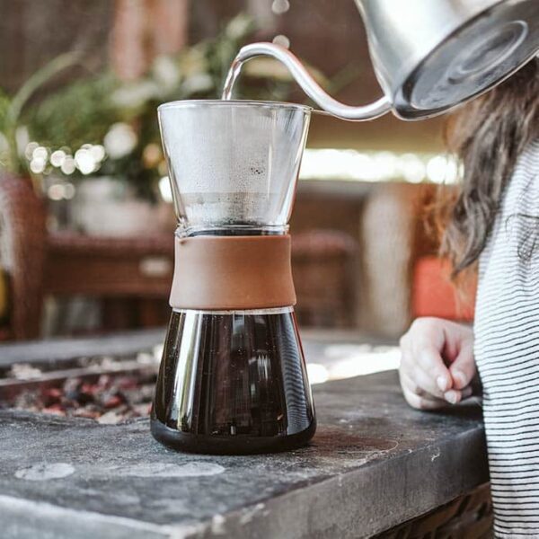 Woman brewing fresh coffee with Grosche Amsterdam Glass Pour Over Coffee Maker from Gimme the Good Stuff 001