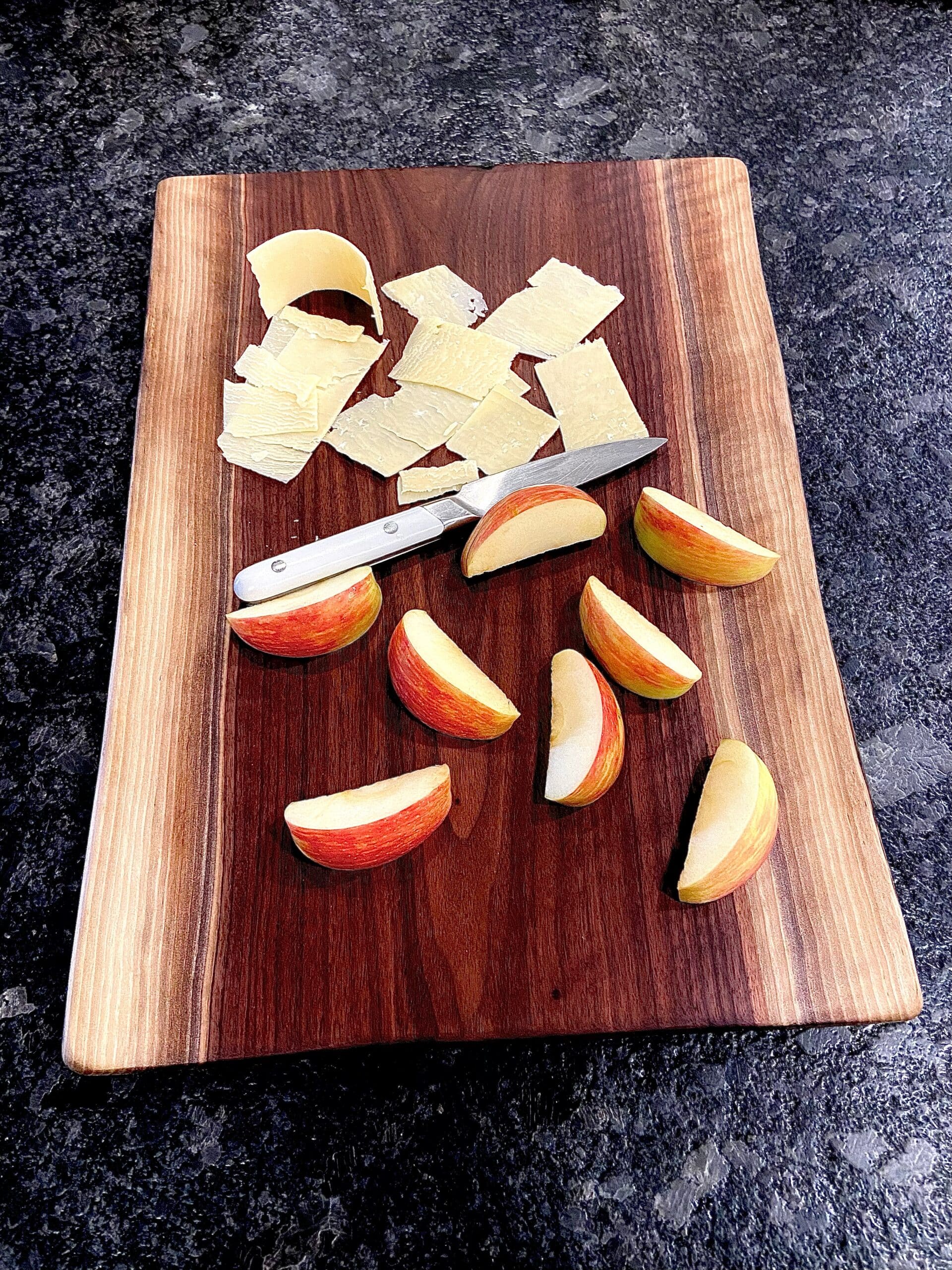 wooden non-toxic cutting board with apples and cheese
