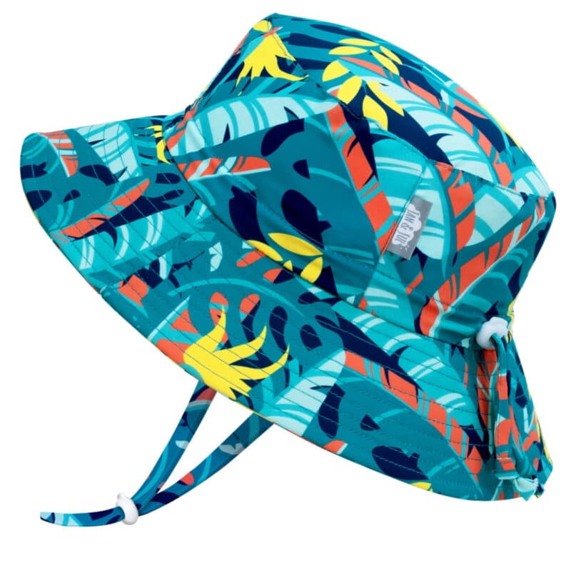 A dark blue kids sun hat with tropical leaf pattern all over it.