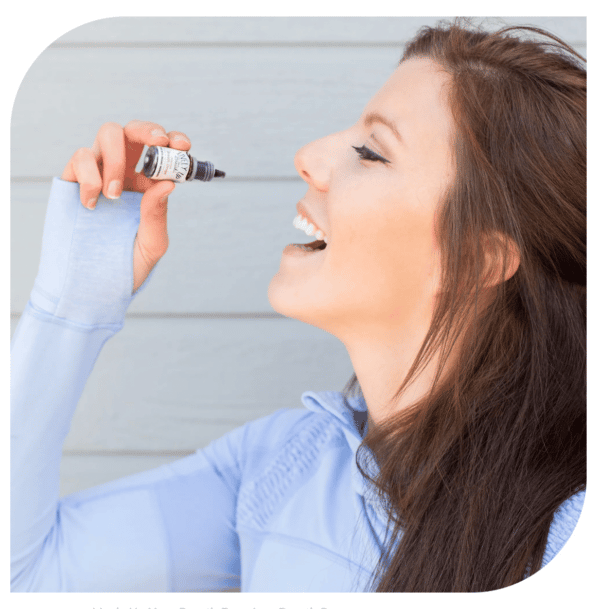 Woman Smiling while Using Lively Up Your Breath Organic Mint Breath Drops