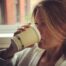 Our founder Maia drinking to-go coffee cup latte.
