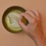 A hand reaching into a jar to make home made DIY Kombucha