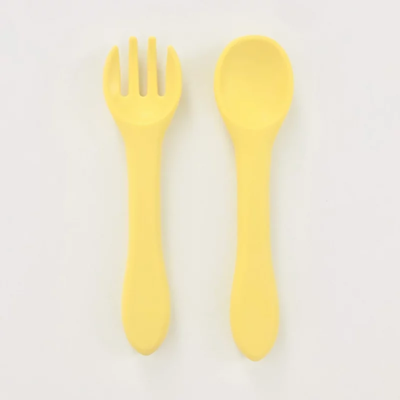 Picture of a yellow silicone fork and spoon for toddlers