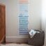 A child bedroom with a growth chart decal stuck to the wall.