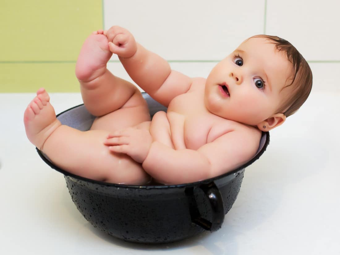 A baby soaks in a breast milk bath to provide relief for her diaper rash