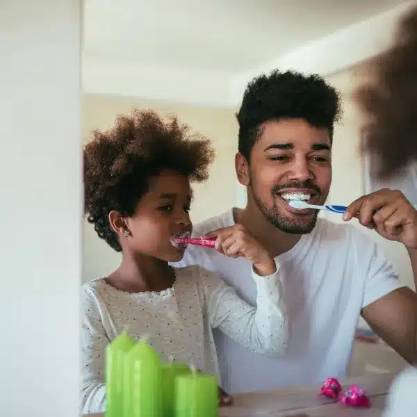 Image of a dad and child brushing teeth. | Gimme The Good Stuff